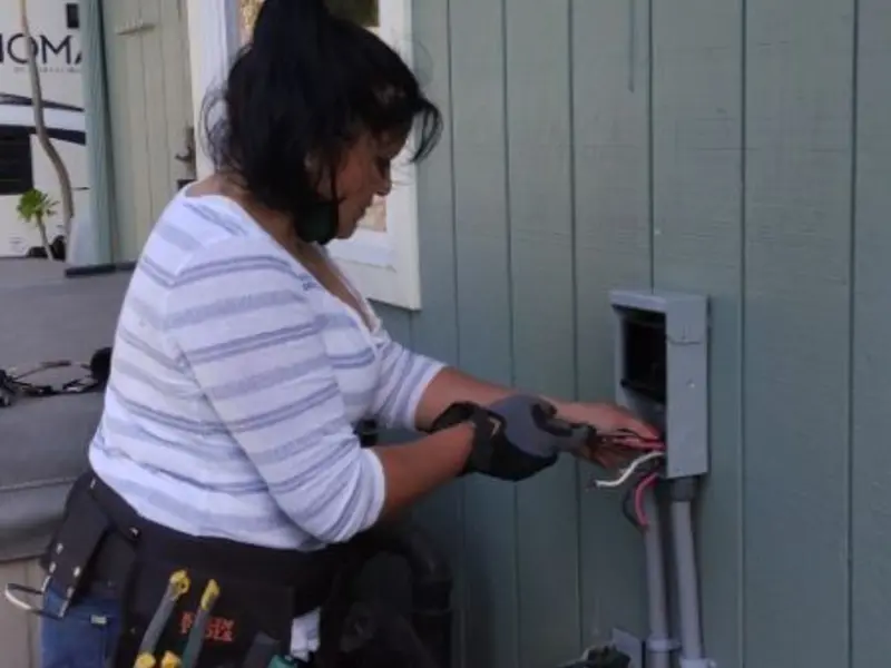 Licensed electrician wiring an exterior subpanel in Maiden